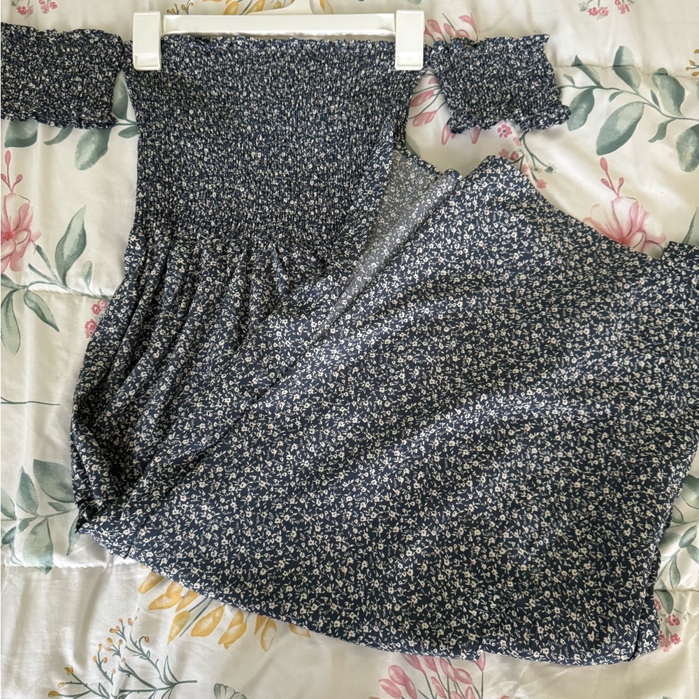 A navy blue and white floral pattern long strapless dress with thigh slit.